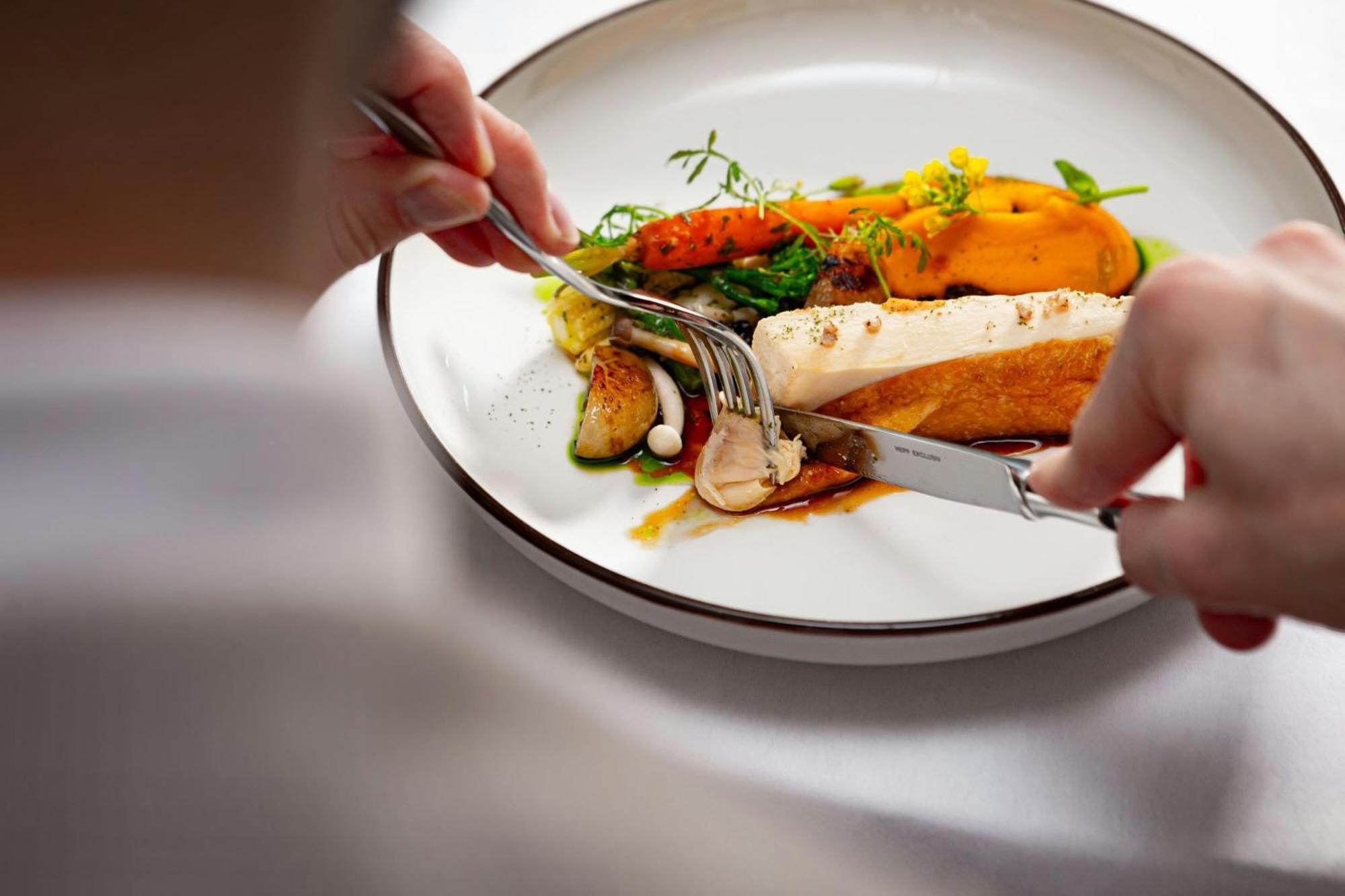 Grand Hotel River Park, A Luxury Collection Hotel, Bratislava Exterior foto A person using a knife and fork to cut into a meal